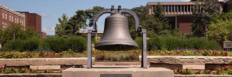 A bell positioned on campus