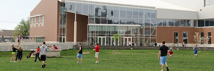 Students participate in activities outside of the Student Fitness Center building.